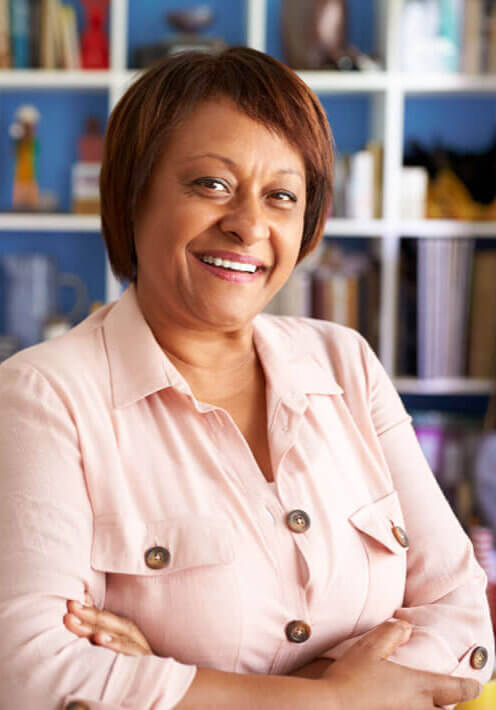 portrait-of-smiling-mature-woman-in-home-office-by-AHW4SC6